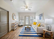 Thumbnail 5 of 36 - a living room with a ceiling fan and hardwood flooring