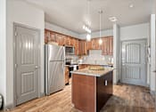 Thumbnail 2 of 36 - a kitchen with wooden cabinets and stainless steel appliances