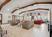 Thumbnail 18 of 36 - a living room filled with furniture and a ceiling with beams