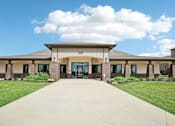 Thumbnail 14 of 33 - the front of a building with a walkway and grass