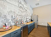Thumbnail 20 of 33 - a kitchen with blue cabinets and a sink and a refrigerator