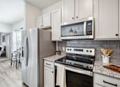Thumbnail 7 of 33 - a kitchen with stainless steel appliances and white cabinets