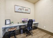 Thumbnail 22 of 33 - a home office with a desk and a painting on the wall
