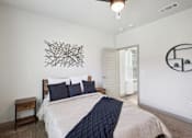 Thumbnail 8 of 33 - a bedroom with a large bed and a wall art above it