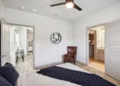 Thumbnail 9 of 33 - a bedroom with a large bed and a ceiling fan    and a bathroom