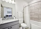 Thumbnail 10 of 33 - a bathroom with a shower toilet and sink and a mirror