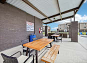 Thumbnail 27 of 33 - an outdoor patio with tables and chairs and a brick wall