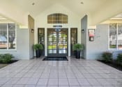 Thumbnail 13 of 40 - an entrance to a building with doors and windows