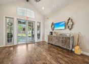 Thumbnail 14 of 40 - the living room of a house with a bar and a door to a patio