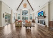 Thumbnail 15 of 40 - a large living room with a fireplace and a large window