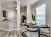 Thumbnail 4 of 35 - A dining area with a table and chairs.