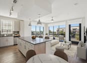 Thumbnail 1 of 55 - A modern kitchen with a large granite island and a view of Plano, Texas.
