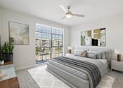 Thumbnail 15 of 55 - A spacious, well-lit bedroom with large windows.