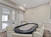 Thumbnail 30 of 33 - a game room with a poker table and chairs