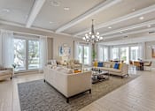 Thumbnail 28 of 33 - a large living room with couches and chairs and a chandelier