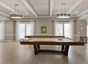 Thumbnail 31 of 33 - a game room with a pool table and windows