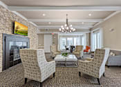 Thumbnail 27 of 33 - a lobby with couches and chairs and a fireplace