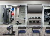 Thumbnail 26 of 28 - the gym is equipped with weights and a television