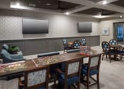 Thumbnail 25 of 28 - a dining room with a table and chairs