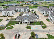 Thumbnail 53 of 55 - an aerial view of a neighborhood of houses with cars in a parking lot