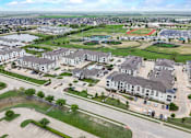 Thumbnail 49 of 55 - an aerial view of a community with houses and a parking lot