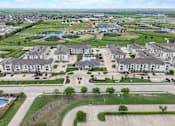 Thumbnail 52 of 55 - an aerial view of a neighborhood with houses and a parking lot
