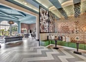 Thumbnail 26 of 35 - Clubhouse lounge with tufted banquette seating, modern tile floors, and open layout.