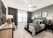 Thumbnail 13 of 35 - Cozy bedroom with ceiling fan, bedside lighting, and a green accent wall.