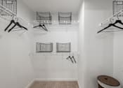 Thumbnail 12 of 35 - Walk-in closet with wire shelving, hanging space, and organized storage baskets.