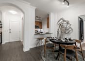 Thumbnail 4 of 35 - Dining nook with arched entryway and kitchen bar seating in an open floor plan.