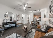 Thumbnail 2 of 35 - Open living and dining area with ceiling fan, wood-style floors, and breakfast bar.