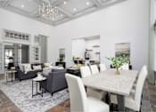 Thumbnail 11 of 25 - A dining room with a table and chairs.