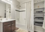 Thumbnail 9 of 48 - a bathroom with a shower and a sink and a mirror