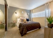 Thumbnail 6 of 21 - a bedroom with a bed and a plant