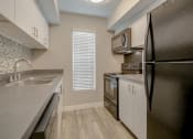Thumbnail 5 of 21 - a kitchen with a sink and a refrigerator