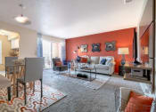 Thumbnail 13 of 21 - a living room and dining room with a couch and a table
