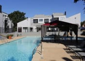 Thumbnail 19 of 21 - our apartments have a swimming pool with a gazebo and chairs