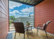 Thumbnail 9 of 21 - a balcony with two chairs and a table