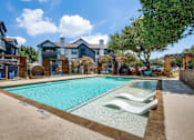 Thumbnail 12 of 35 - A swimming pool surrounded by a fence and chairs.