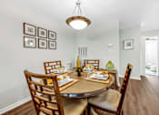 Thumbnail 13 of 42 - a dining room with a table and chairs