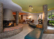 Thumbnail 24 of 45 - a living room filled with furniture and a large fireplace