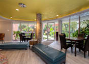 Thumbnail 22 of 45 - a living room with a large yellow ceiling and large windows