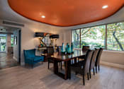 Thumbnail 21 of 45 - a dining room with a wooden table and blue chairs