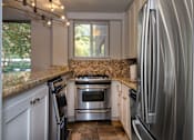 Thumbnail 18 of 45 - a kitchen with white cabinets and stainless steel appliances