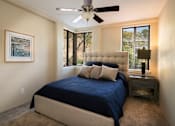 Thumbnail 10 of 45 - a bedroom with a bed and a ceiling fan