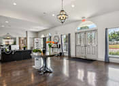 Thumbnail 15 of 36 - a living room with white walls and a table