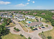 Thumbnail 35 of 36 - an aerial view of an apartment complex with cars parked in a parking lot