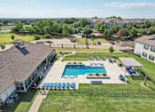 Thumbnail 25 of 36 - an aerial view of a swimming pool in front of a house