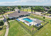 Thumbnail 26 of 36 - an aerial view of a swimming pool in front of a house