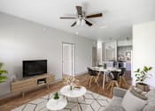 Thumbnail 3 of 39 - a living room with a ceiling fan and a dining room in the background